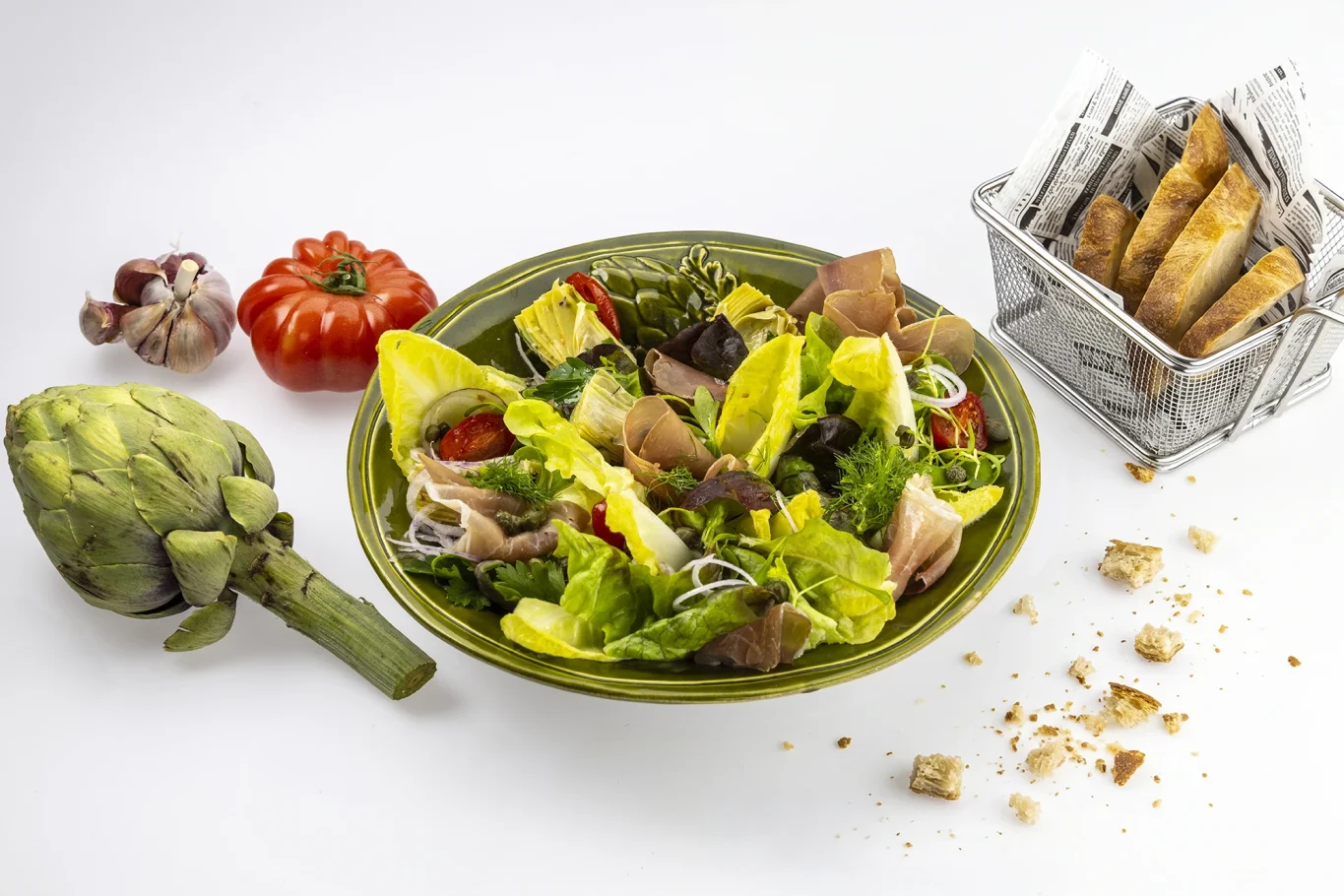Bunte Salatschüssel mit frischem Gemüse, Artischocke und knusprigen Brotsticks.